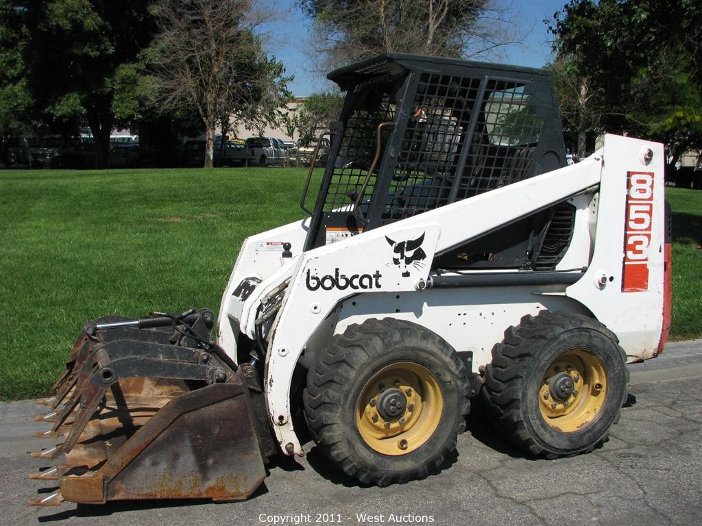 West Auctions Auction 1994 Bobcat Skid Steer Loader With Grapple Bucket And Forklift Attachment Item 1994 Bobcat Skid Steer Loader With Grapple Bucket And Forklift Attachment