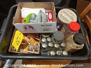 Bin Of Assorted Salt And Pepper Shakers, Hot Sauce Packets, Honey Packets, And More